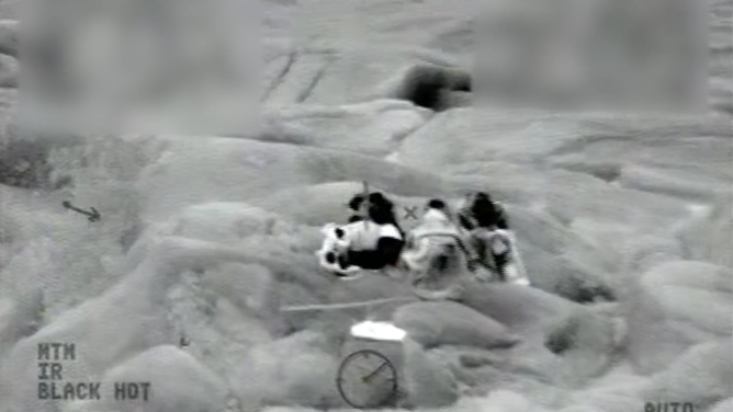 The children huddled on the rock.
